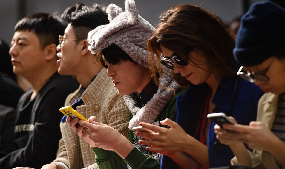 A group of people looking at their mobile phones